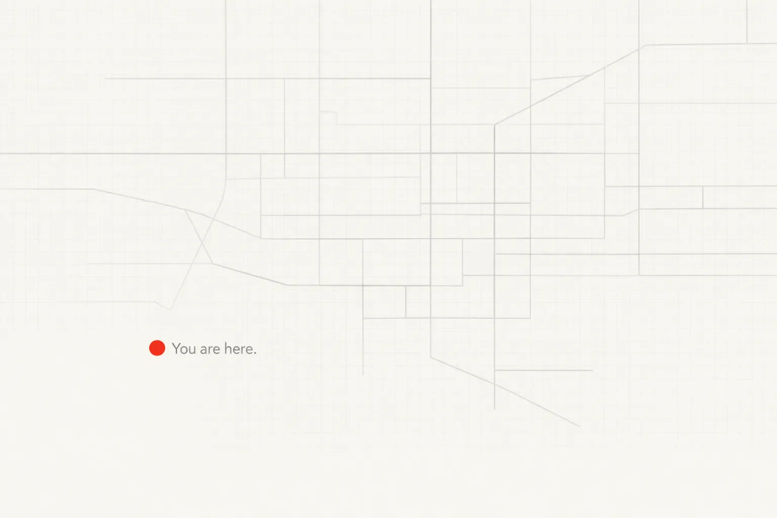 Minimal off-white composition with a faint, incomplete grey grid system; a small orange dot in the lower-left quadrant marks position beside the text “You are here.”